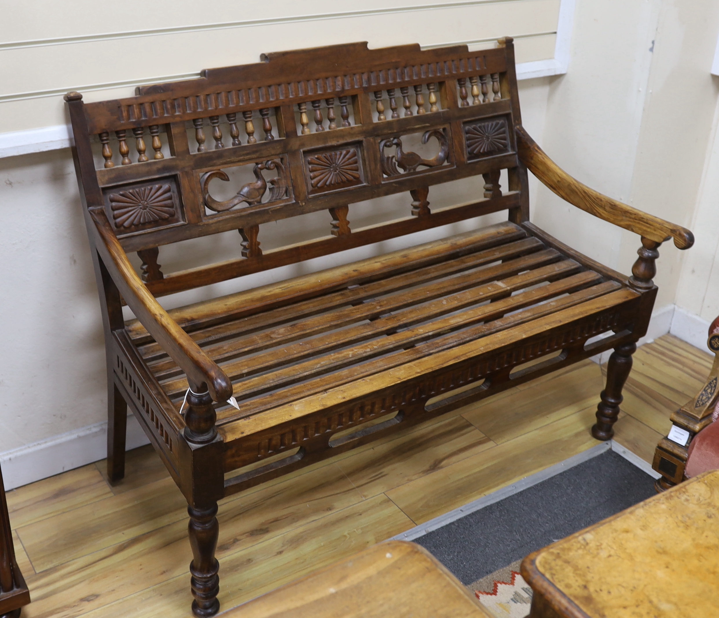 A Javanese carved hardwood bench, width 119cm, depth 65cm, height 98cm